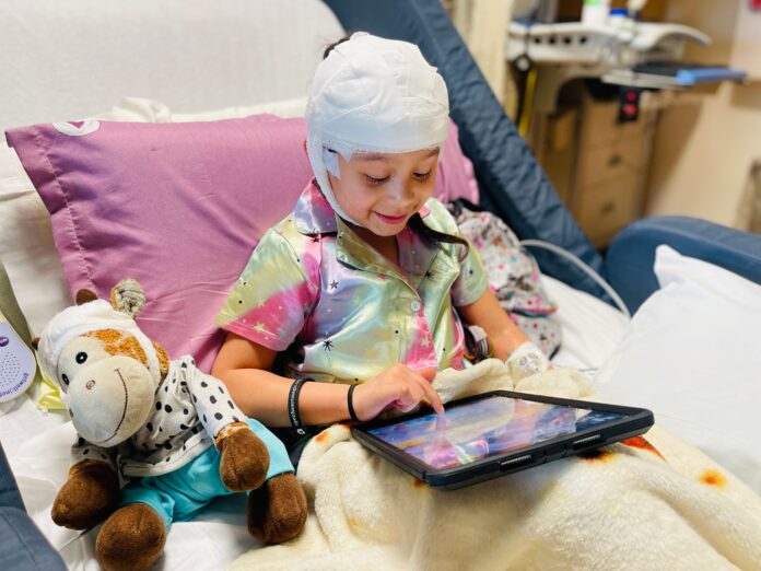 Young patient playing with iPads